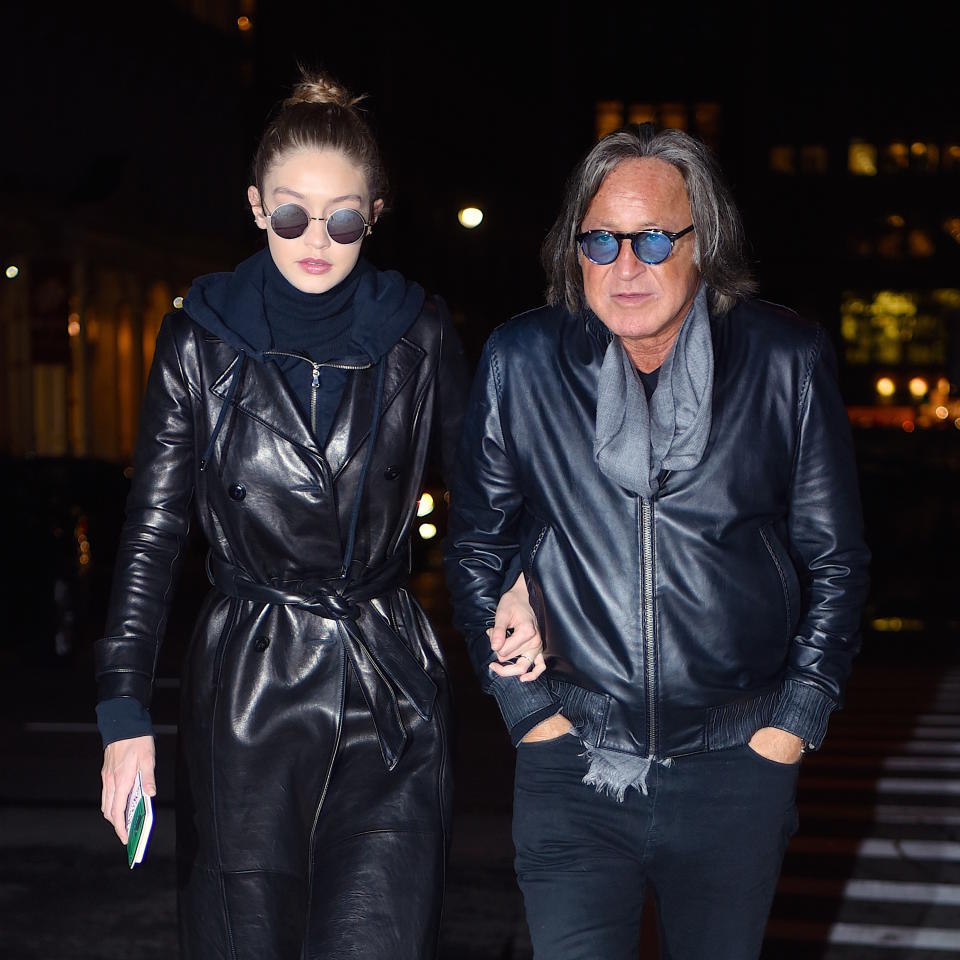 Gigi walking with her hand through her dad's arm