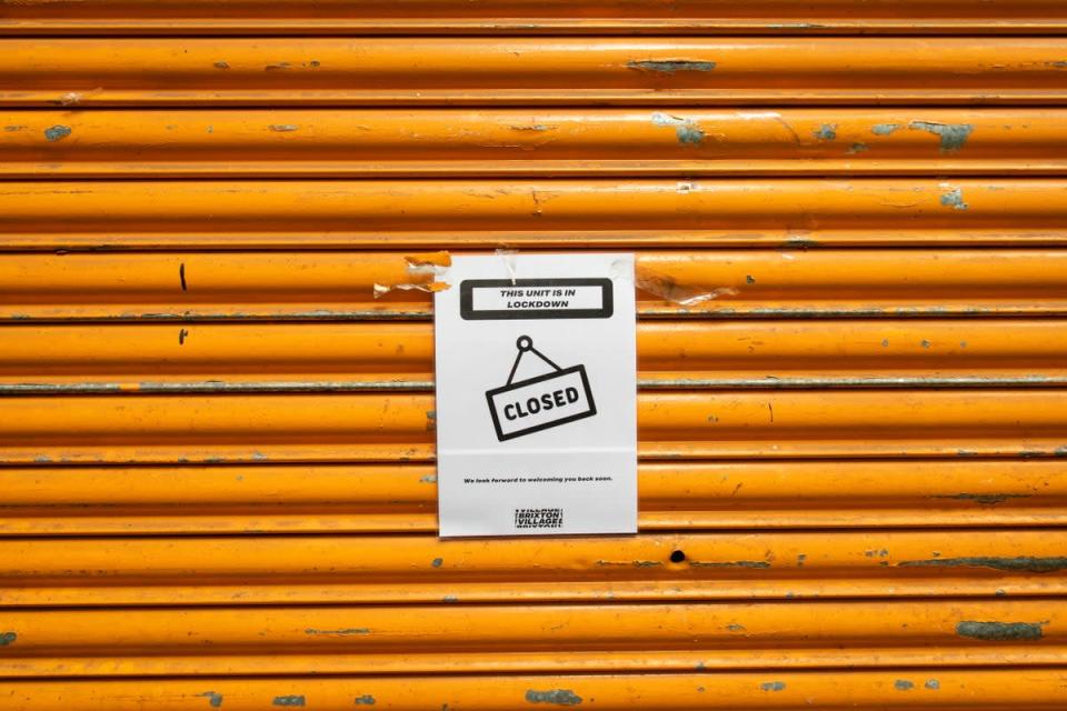 A closed sign outside a shuttered shop unit in Brixton (Dominic Lipinski/PA) (PA Archive)
