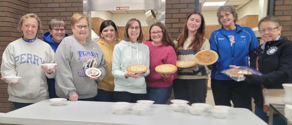 Stop & Smell the Flours owner Daphane Bjork of Kelley, fourth from the left, held a Pies for Perry event Jan. 11, where people in the community received about 600 slices of free pie. Bjork is pictured here with several of the volunteers who helped her at the event.