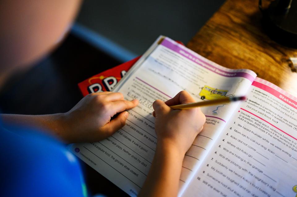 William Gordon, 8, a student at Woodland Elementary School in Greer, S.C., does compound-sentence exercises at home Aug. 24.