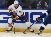 Nov 18, 2017; Tampa, FL, USA; New York Islanders center John Tavares (91) attempts to control the puck in the third period against the Tampa Bay Lightning at Amalie Arena. Mandatory Credit: Jonathan Dyer-USA TODAY Sports