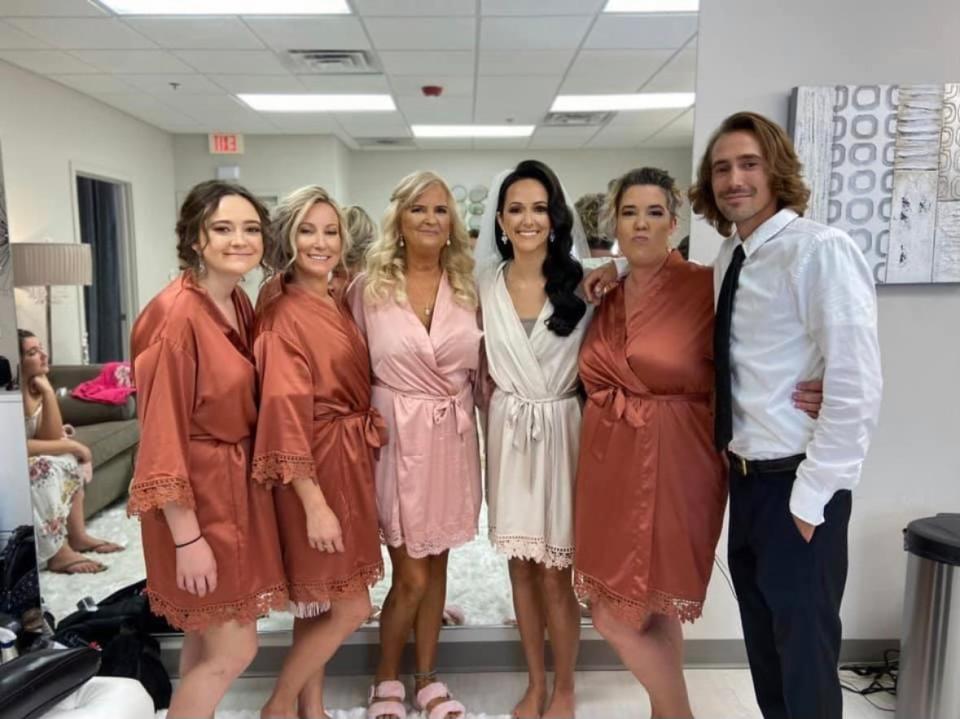 (From left to right) Kiana Jensen, Keshia Jensen, Terri Jensen, Kyndra Smith, Kacy Munden and Kody Jensen are pictured on Smith's wedding day in August 2020 in Omaha, Nebraska. Smith says Terry Jensen was best friends with her and all the siblings.