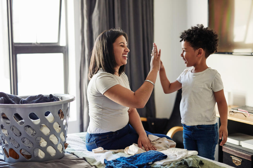 mom highfiving her young son at home