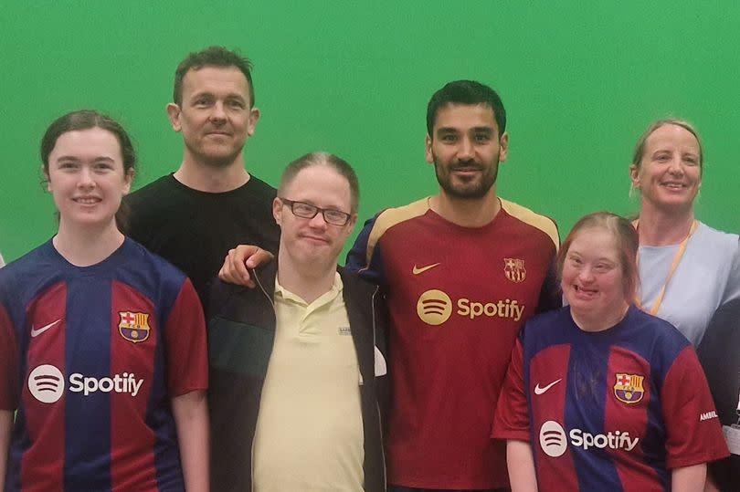 Ilkay Gundogan poses with City fans Katie, Daniel and Kayley, plus staff members of Community Integrated Care after inviting the group to Barcelona this week.