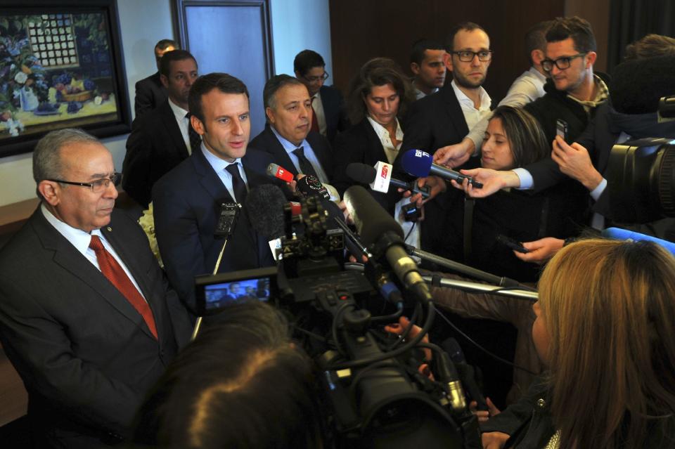 French Presidential candidate Emmanuel Macron, second left, answers reporters with Algerian Foreign Minister Ramtane Lamamra, left, in Algiers, Monday Feb. 13, 2017. Claims made by Macron's campaign chairman Richard Ferrand Monday, assert that Russian groups are interfering with his presidential campaign but have offered little evidence to back up the claim. (AP Photo/Anis Belghoul)