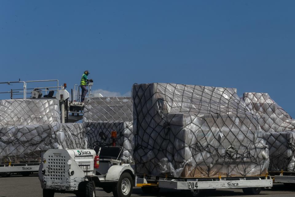 Workers at a Venezuela airport unload humanitarian aid from China on March 28, 2020.