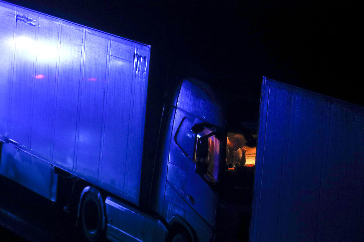 A drive sits in the cab of his lorry while parked on the M20 in Kent after the Port of Dover was closed after the French government's announcement it will not accept any passengers arriving from the UK. France appears set to end a ban on hauliers crossing the Channel which was imposed due to fears about the spread of the new coronavirus strain. (Photo by Steve Parsons/PA Images via Getty Images)