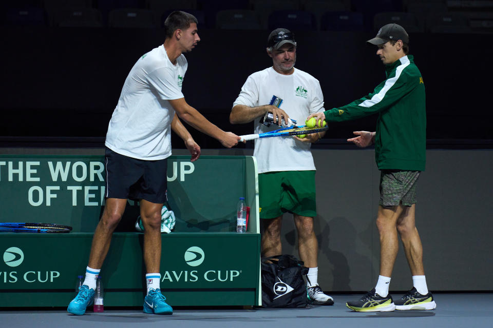 MALAGA, SPAIN - NOVEMBER 18: Alex de Minaur of Australia gives tennis balls to his team mate Alexei Popyrin during a practice session ahead of the Davis Cup Final at Palacio de Deportes Jose Maria Martin Carpena on November 18, 2023 in Malaga, Spain. (Photo by Angel Martinez/Getty Images for ITF)