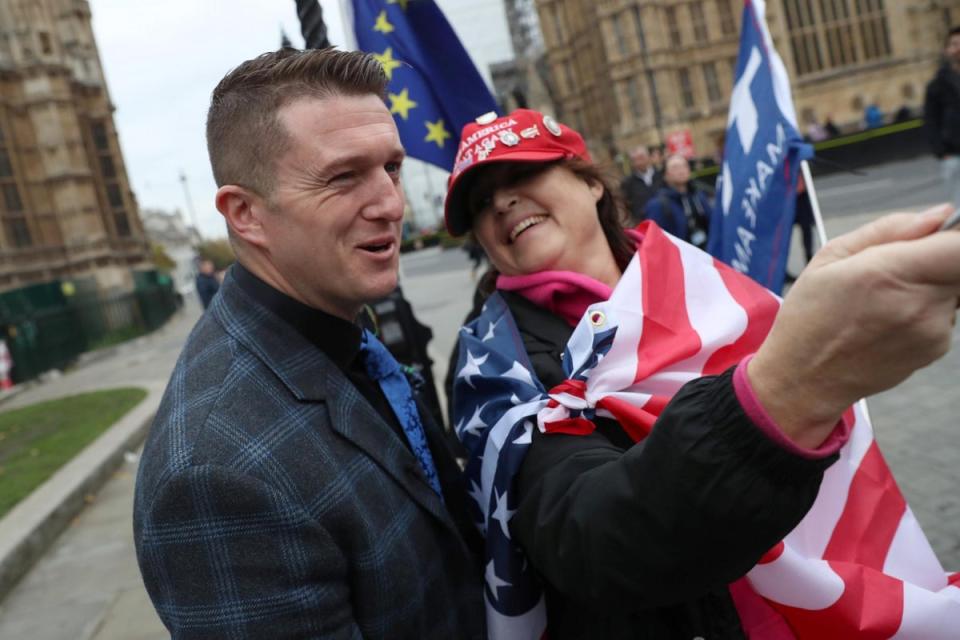 Far right activist Stephen Yaxley-Lennon, who goes by the name Tommy Robinson, poses for a selfie with a Donald Trump supporter (REUTERS)