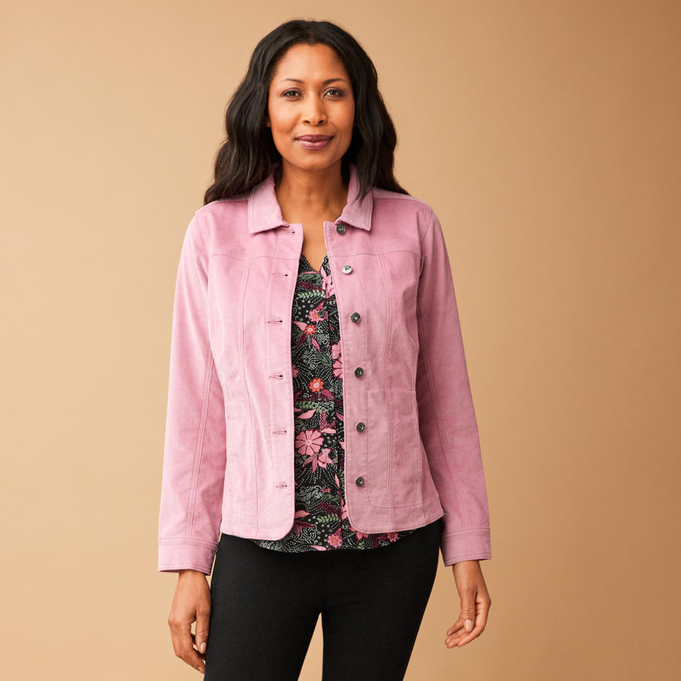 black model wearing black pants, floral top and pink Smart Corduroy Blazer Jacket (Photo via Northern Reflections)