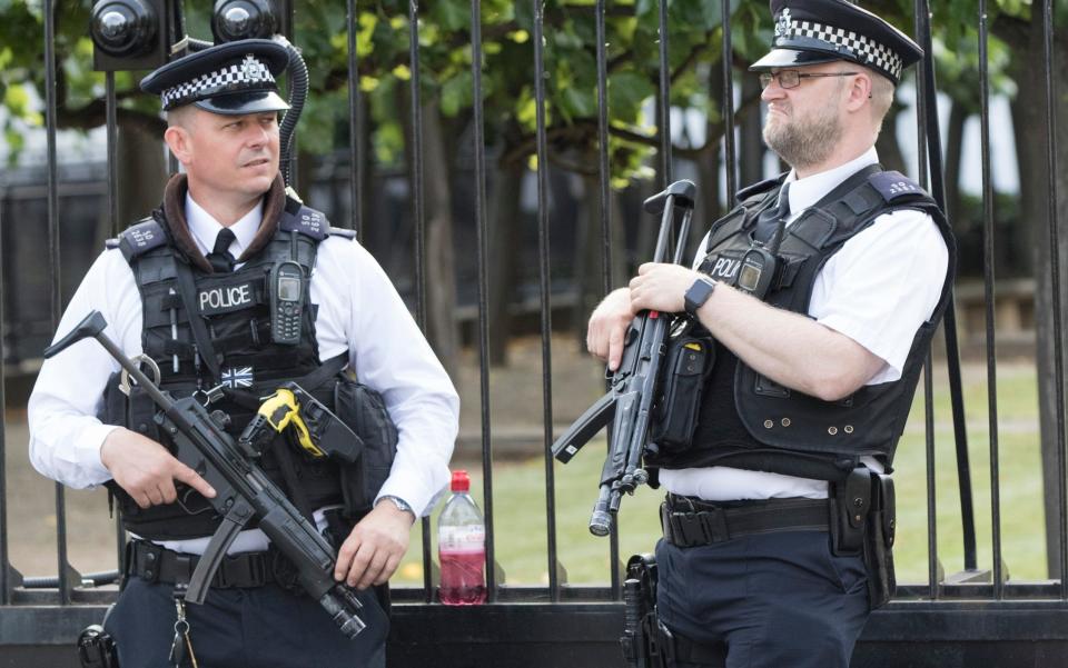 Armed police on patrol in London last week. Officers at Wimbledon will operate a shoot-to-kill policy to counter the threat of suicide attacks - Nick Edwards