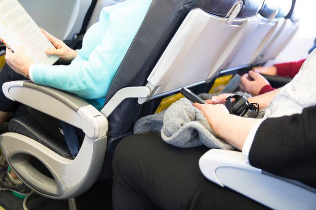 <p>Getty</p> Passengers sitting down on an airplane