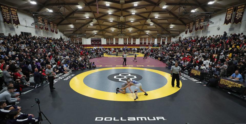 Wrestlers and fans pack into The Dome to watch the final round of the Ironman wrestling tournament at Walsh Jesuit High School in December.