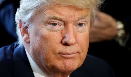 U.S. President Donald Trump looks up after signing an executive order rolling back regulations from the 2010 Dodd-Frank law on Wall Street reform at the White House in Washington February 3, 2017. REUTERS/Kevin Lamarque