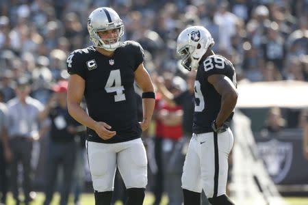 Sep 17, 2017; Oakland, CA, USA; Oakland Raiders quarterback Derek Carr (4) reacts after being called for a false start against the New York Jets in the fourth quarter at Oakland Coliseum. Cary Edmondson-USA TODAY Sports