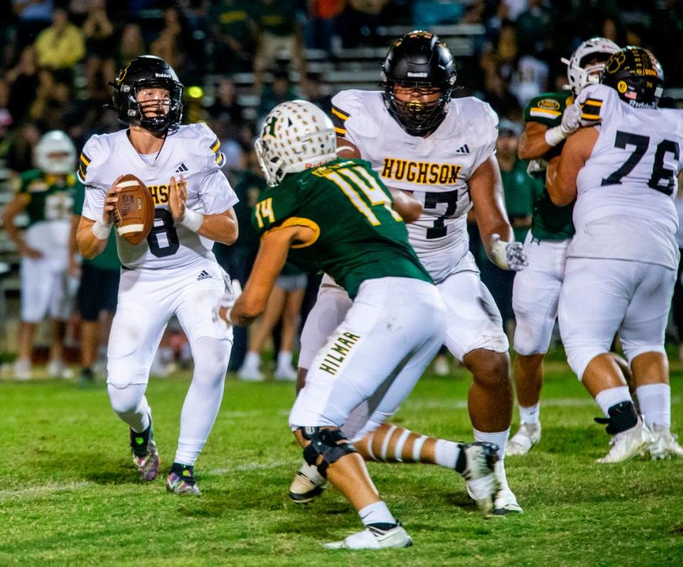Robert Mcdaniel, 8, looks upfield for an open man as teammate Navi Arretche, 77, blocks Devin Colston, 14 of Hilmar High during the first half of Friday Oct. 20, 2023 nights game at Hilmar.