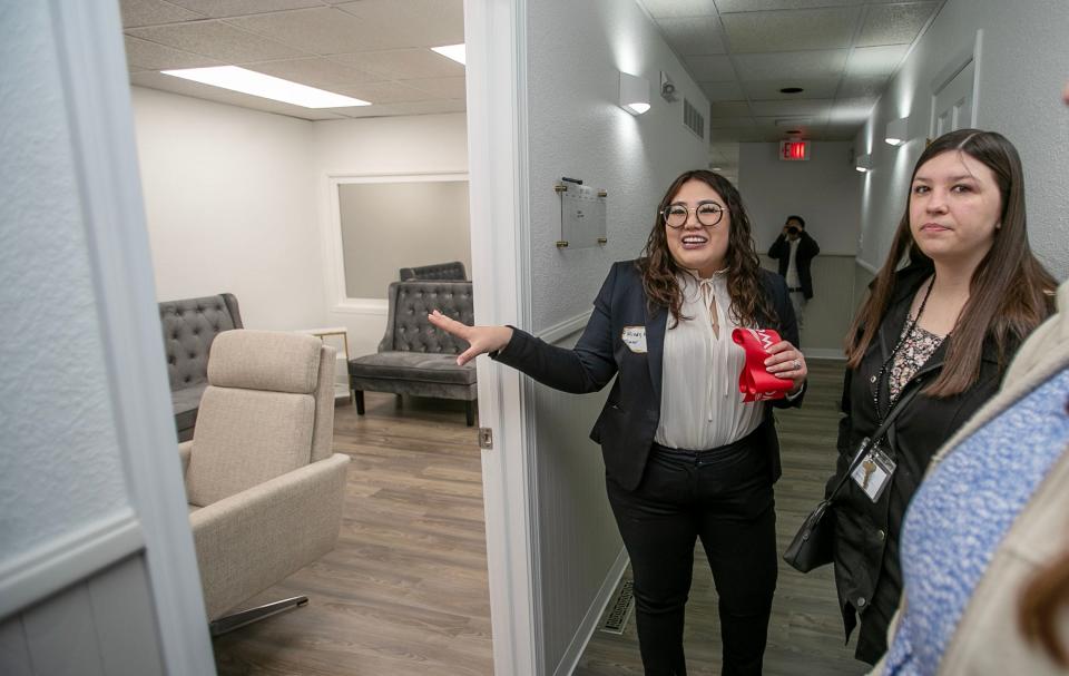 Mindy Kue, of Blooming Minds Psychotherapy, center, points out a room at Blooming Minds Psychotherapy, LLC, Friday, May 26, 2023, in Sheboygan, Wis.