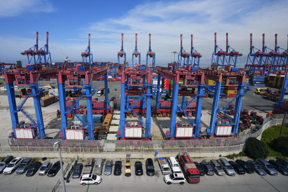 Gantry cranes move containers onto transporters at the Beirut Port, in Beirut, Lebanon, Wednesday, March 13, 2024. Three and a half years after hundreds of tons of improperly stored ammonium nitrate ignited at the Beirut port, setting off one of the world's biggest non-nuclear explosions, Lebanese and French officials put forward a plan for reconstruction and reorganization of the port Wednesday. (AP Photo/Bilal Hussein)