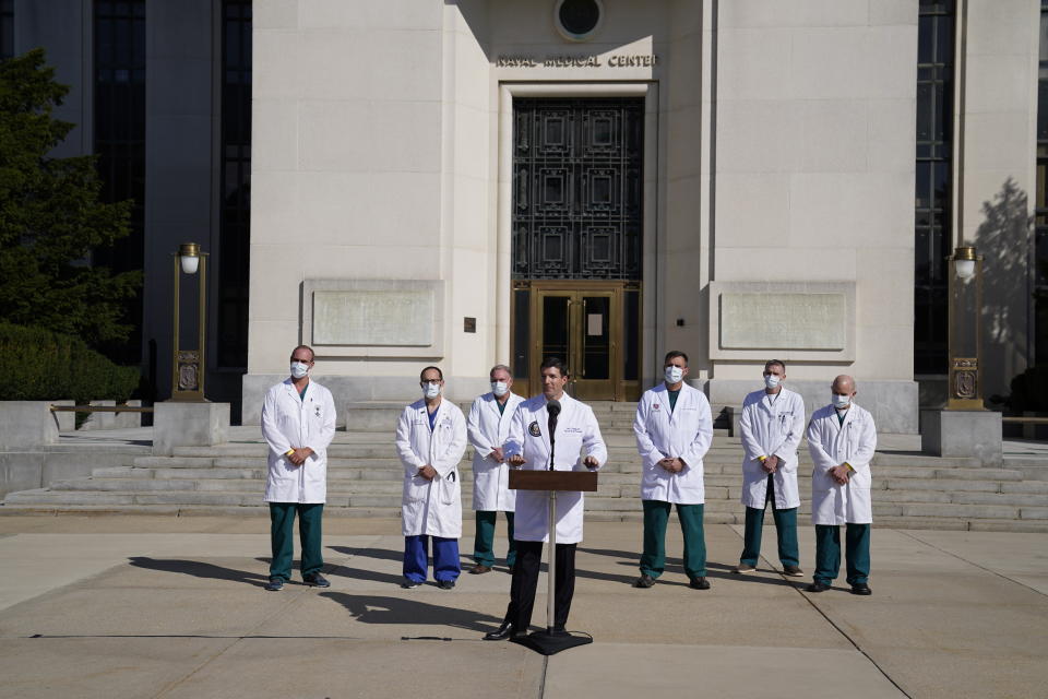 Dr. Sean Conley, physician to President Donald Trump, center, talks with reporters at Walter Reed National Military Medical Center, Monday, Oct. 5, 2020, in Bethesda, Md. (AP Photo/Evan Vucci)