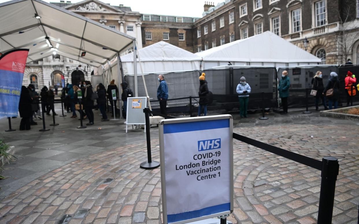 People queue outside a Covid-19 vaccination centre in Guy's hopsital in London - FACUNDO ARRIZABALAGA/PA-EFE/Shutterstock