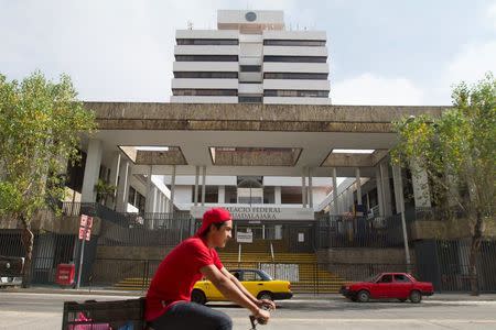 A cyclist pedals past the Jalisco state immigration office, where Ethan Couch and his mother Tonya are in custody and waiting for deportation, in Guadalajara, Mexico, December 30, 2015. REUTERS/Javier Hoyos