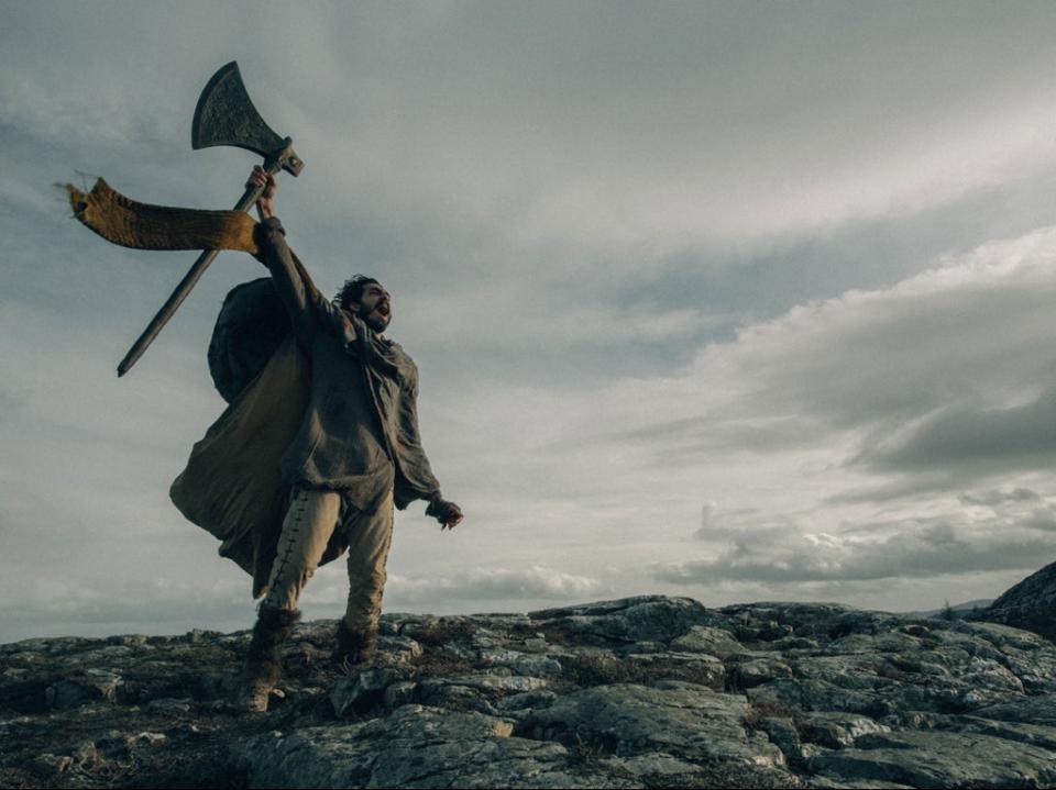 Gawain’s (Dev Patel) ochre-dyed cloak stands out beautifully against the film’s earthy, frost-bitten backdrops (Entertainment Film)