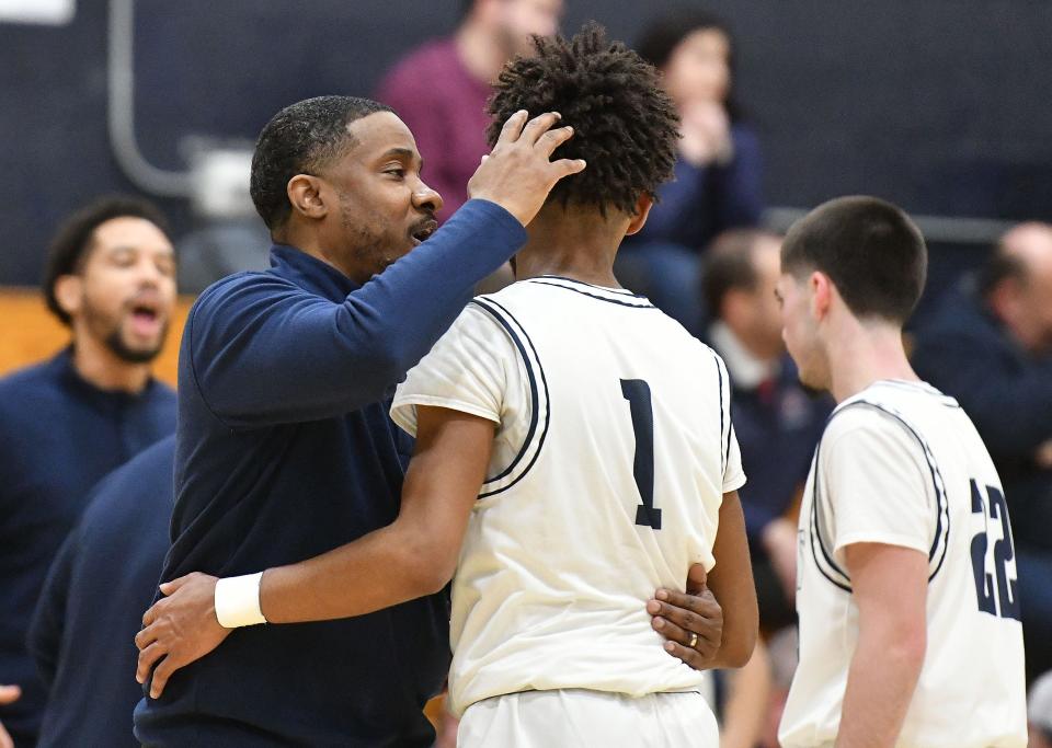 Rochester coach Sean Keaton talks to guard Duriel Smith during a WPIAL Class 1A playoff game Friday night at Rochester Area High School.