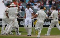 England's Joe Root (C) walks off the field after his dismissal as Australia's team celebrate during the fourth day's play in the second Ashes cricket test at the Adelaide Oval December 8, 2013.