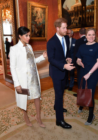 Britain's Meghan, Duchess of Sussex and Prince Harry the Duke of Sussex are seen at a reception to mark the fiftieth anniversary of the investiture of the Prince of Wales at Buckingham Palace in London, Britain March 5, 2019. Dominic Lipinski/Pool via REUTERS