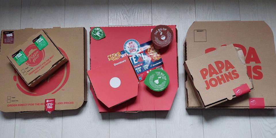 Boxes of pizza from Pizza Hut, Domino's, and Papa John's