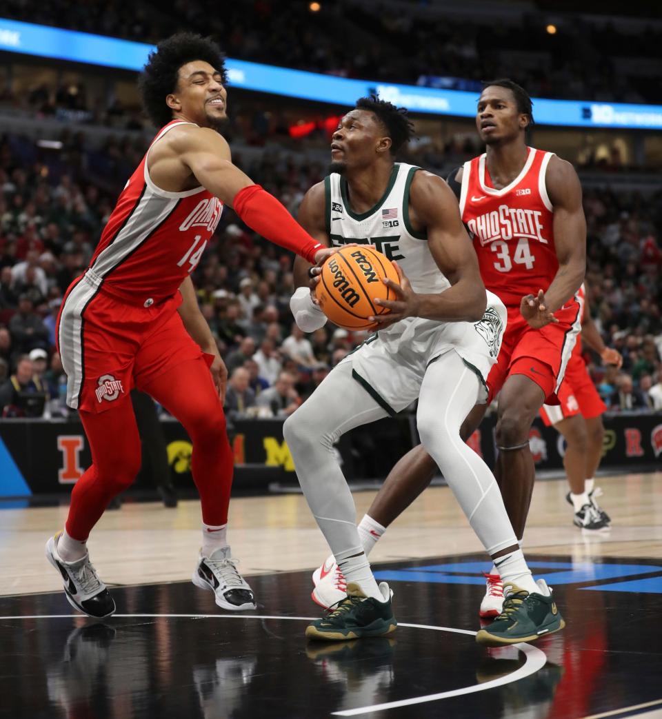 Michigan State Spartans center Mady Sissoko rebounds against Ohio State Buckeyes forward Justice Sueing (14) during the first half of the Big Ten tournament quarterfinals in Chicago, Friday, March 10, 2023.