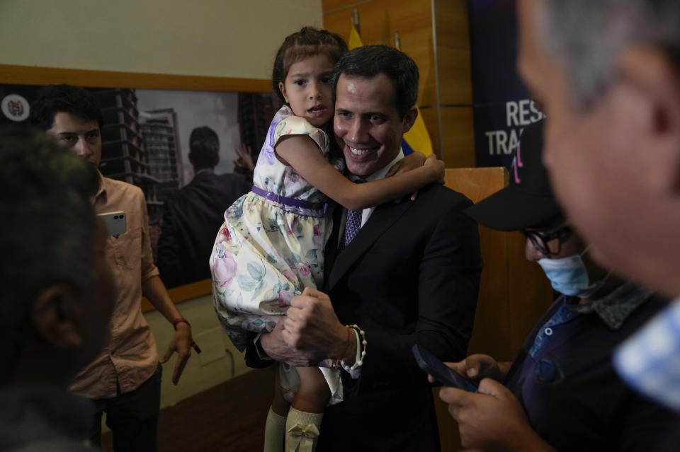 Opposition leader Juan Guaido holds his daughter Miranda Eugenia after giving a news conference to explain the income and expenses of his self-proclaimed, parallel government in Caracas, Venezuela, Friday, Sept. 16, 2022. The U.S. and other nations recognized Guaido as Venezuela’s interim president when they withdrew recognition of President Nicolas Maduro after accusing him of rigging his 2018 re-election as president. (AP Photo/Ariana Cubillos)