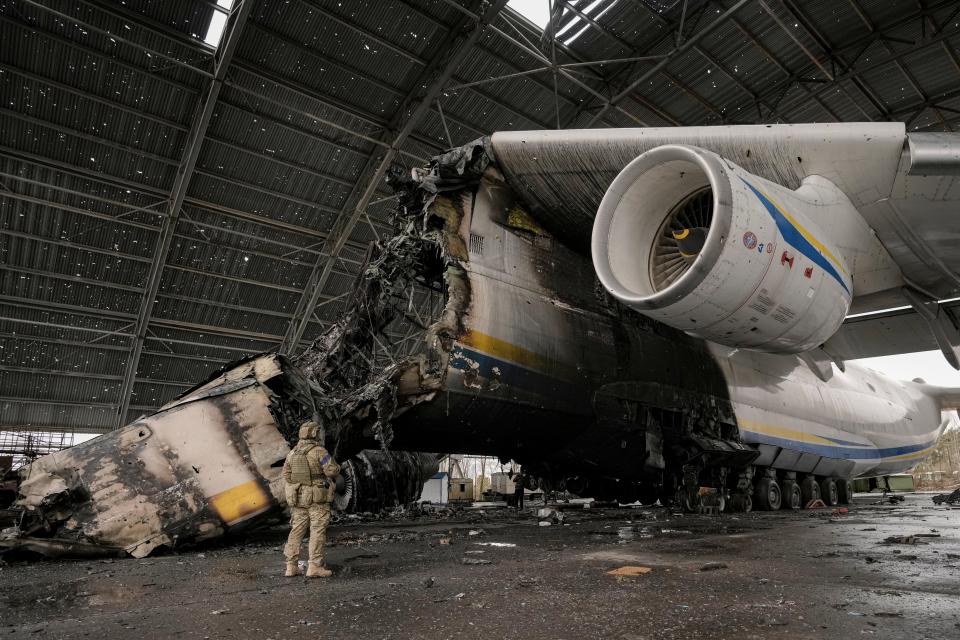 A Ukrainian serviceman observes the Antonov An-225 Mriya aircraft.