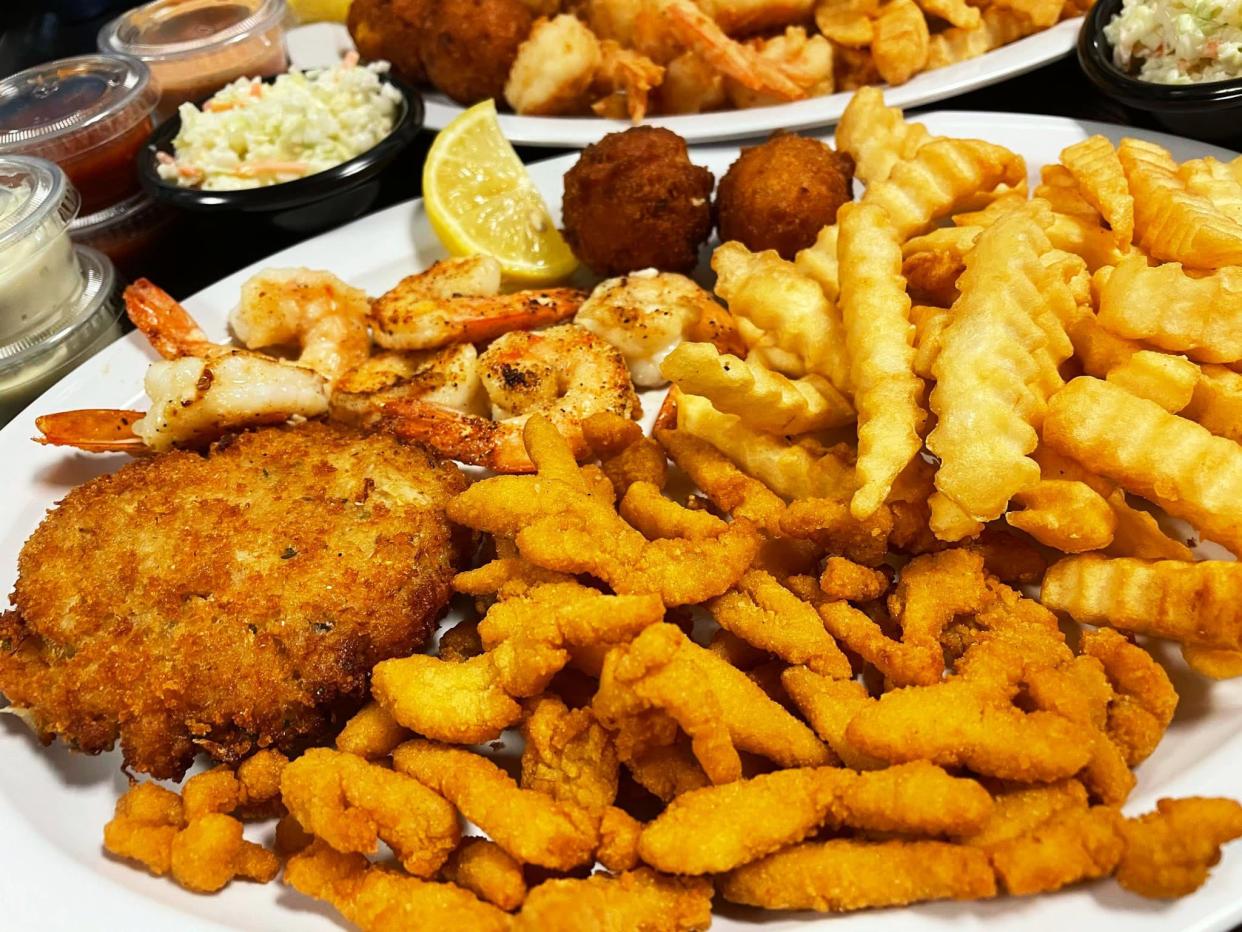 Grilled shrimp, crab cakes and clam strips plus french fries, hush puppies and cole slaw at Sid and Linda's Seafood Market & Restaurant, 12220 Atlantic Blvd.