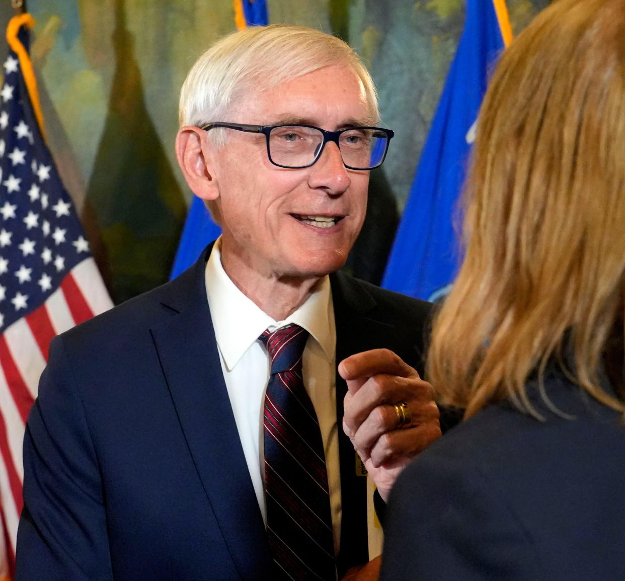 Wisconsin Governor Tony Evers, left, talks with Rebekah Sweeney, right, from the Wisconsin Cheese Makers Association, following the signing of  the biennial budget at the State Capitol in Madison on Wednesday, July 5, 2023.