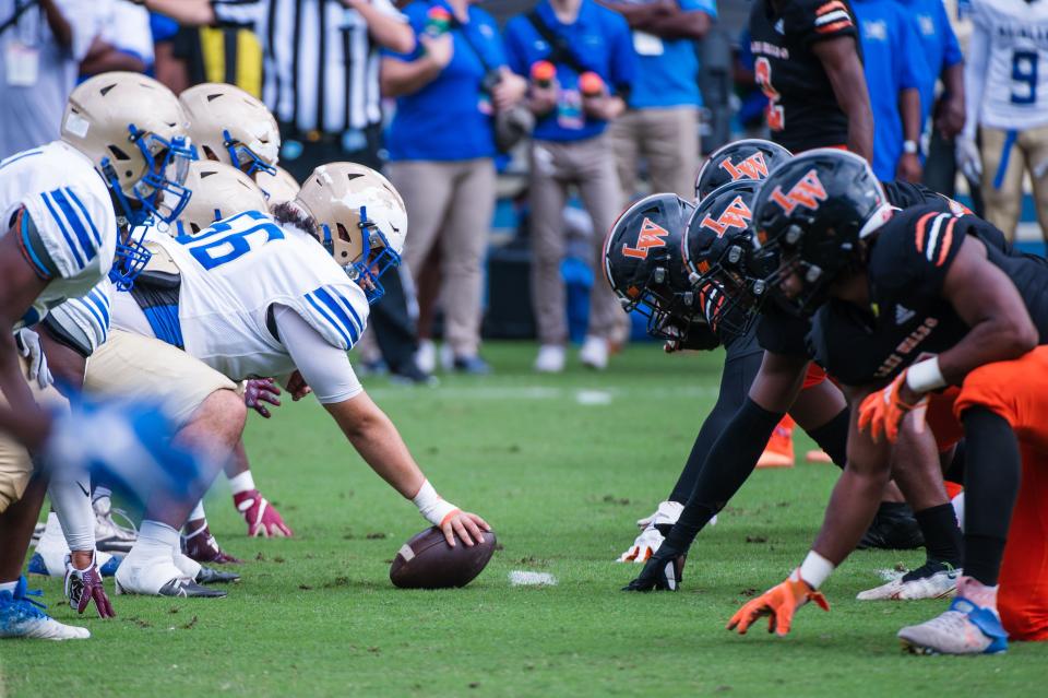 The Mainland Buccaneers and the Lake Wales Highlanders face off at the line of scrimmage in the first quarter during the Class 3S football state championship game between Lake Wales and Mainland at DRV PNK Stadium on Friday, December 16, 2022, in Fort Lauderdale, FL.