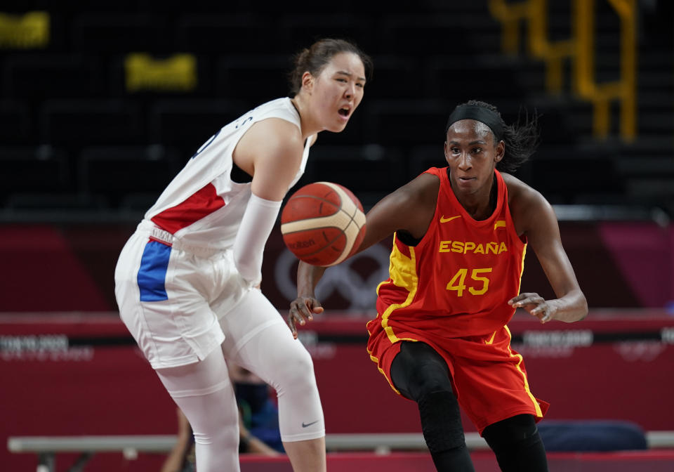 South Korea's Ji Su Park (19), left, and Spain's Astou Ndour (45) fight for loose ball during women's basketball preliminary round game at the 2020 Summer Olympics, Monday, July 26, 2021, in Saitama, Japan. (AP Photo/Charlie Neibergall)