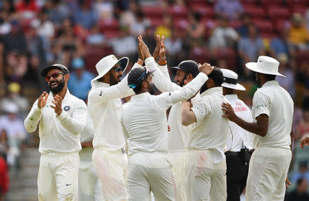 India's captain Virat Kohli (L) reacts with teammates after the dismissal of Australia's Peter Handscomb on day four of the first test match between Australia and India at the Adelaide Oval in Adelaide, Australia, December 9, 2018. AAP/Dave Hunt/via REUTERS