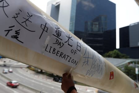 A man prays as people gather near the Legislative Council building to wait for a government announcement regarding the proposed extradition bill, in Hong Kong,