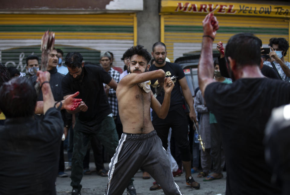 Kashmiri Shiite Muslims flagellate themselves during a Muharram procession in Srinagar, Indian controlled Kashmir, Saturday, Aug. 29, 2020. Muharram is a month of mourning in remembrance of the martyrdom of Imam Hussein, the grandson of Prophet Mohammed. Authorities had imposed restrictions in parts of Srinagar, the region's main city, to prevent gatherings marking Muharram from developing into anti-India protests. (AP Photo/Mukhtar Khan)