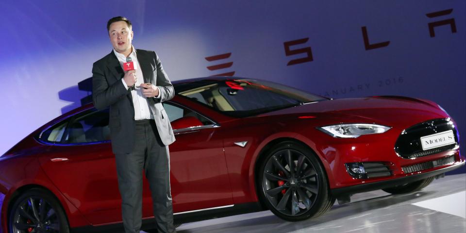 Tesla Motors CEO Elon Musk speaks to the media next to its Model S in Hong Kong on January 25, 2016.