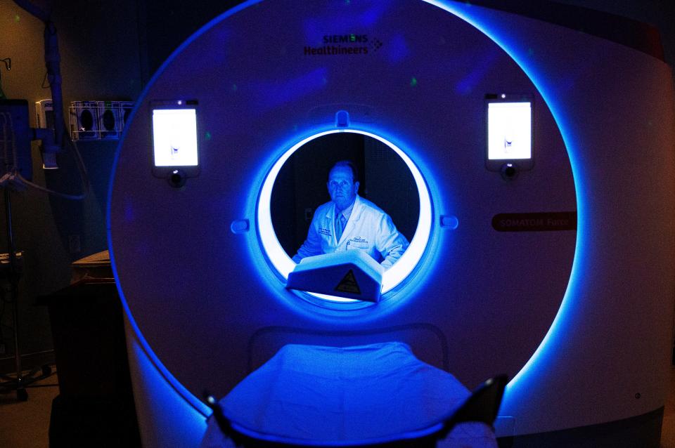 Dr. Richad Chazal, the Medical Director of the Heart and Vascular Institute at Lee Health sits for a portrait with a CT scanner at HealthPark Medical Center in Fort Myers onThursday, Sept. 14, 2023. He is using Cleerly AI technology with his patients. The patient has a CT scan. The scan is sent to Cleerly where it is analyzed and sent back to the doctor. It is an artificial intelligence-based preventative test that helps with identifying plaque build-up that can lead to a heart attack if left untreated.