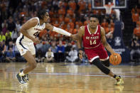 Virginia's Armaan Franklin (4) defends against North Carolina State's Casey Morsell (14) during the first half of an NCAA college basketball game in Charlottesville, Va., Tuesday, Feb. 7, 2023. (AP Photo/Mike Kropf)