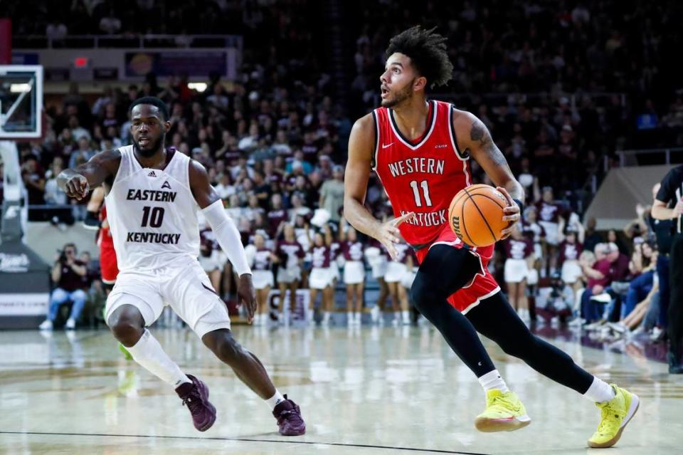 Western Kentucky guard Dontaie Allen (11) drives to the hoop around Eastern Kentucky guard Devontae Blanton (10) during a game at Baptist Health Arena in Richmond in 2022. Allen leads the Hilltoppers in 3-point shooting percentage during the 2023-24 season.