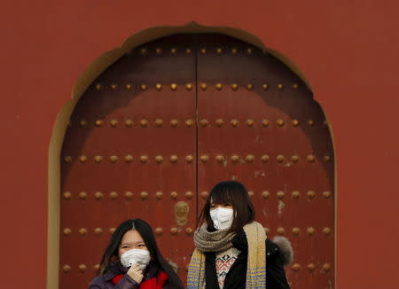 Women wearing protective masks visit the Temple of Heaven park as China's capital Beijing braces for four days of choking smog starting Saturday, in Beijing, China, in this December 19, 2015 file photo. REUTERS/Kim Kyung-Hoon/Files