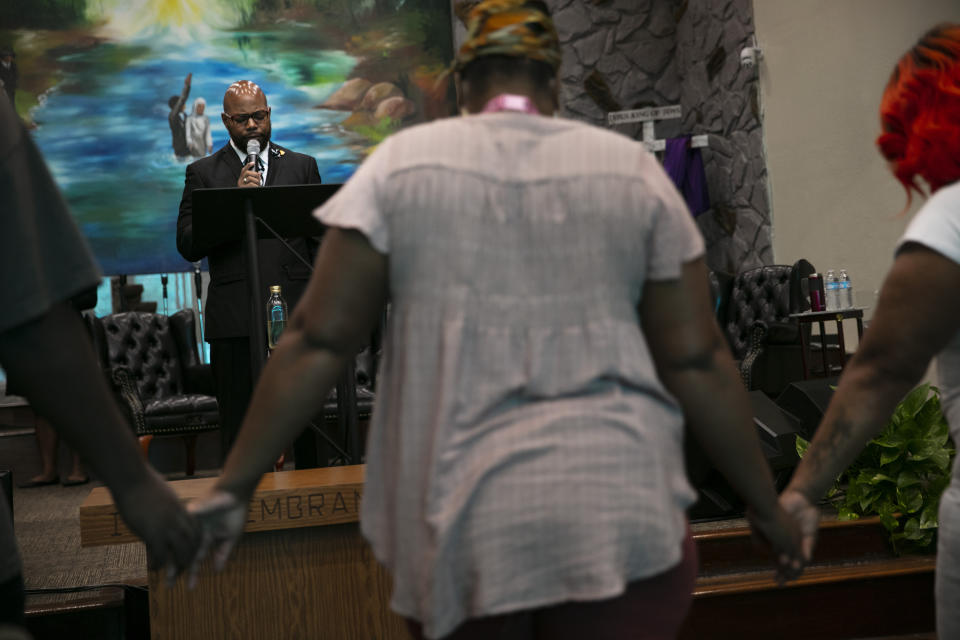 The Rev. Marcus Murchinson leads a prayer during a Sunday service at Tree of Life Missionary Baptist Church Sunday, June 21, 2020, in the Watts neighborhood of Los Angeles. Churches are the heart of the Black community, Murchinson said. In addition to ministering to the faithful, churches provide food, clothing and recreation programs for children. Murchinson also runs a charter school and drug rehab clinics. (AP Photo/Jae C. Hong)