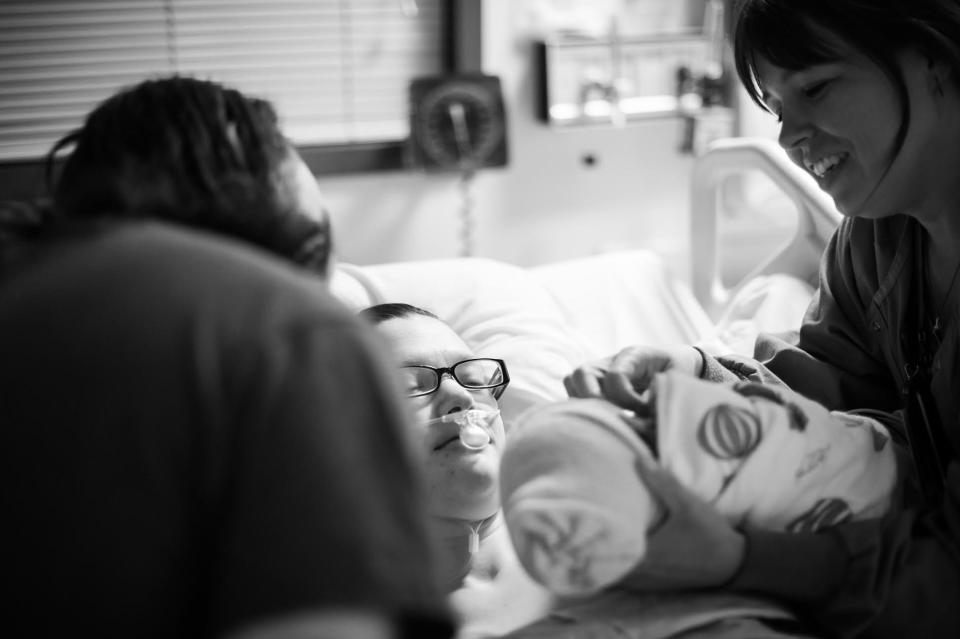 "Tristan (RN) introduces Keilan to his mother Danielle for the first time in the ICU, almost 48 hours after his birth via crash C-section. Danielle narrowly survived HELLP syndrome, which caused her liver to rupture in early labor. This image was taken just after she first regained consciousness after the C-section and surgery to repair her liver and was able to meet her baby (and learn it was a boy). There was not a dry eye on that entire floor."