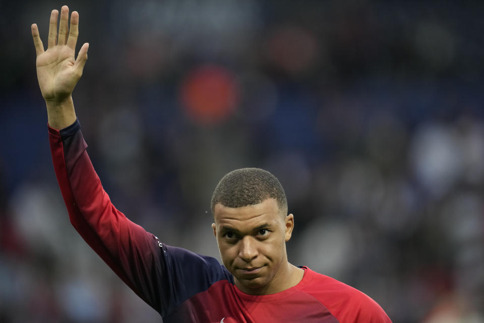 PSG's Kylian Mbappe greets supporters before the French League One soccer match between Paris Saint-Germain and Toulouse at the Parc des Princes stadium in Paris, Sunday, May 12, 2024. (AP Photo/Christophe Ena)