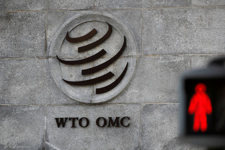 FILE PHOTO: A logo is pictured outside the World Trade Organization (WTO) headquarters next to a red traffic light in Geneva, Switzerland, October 2, 2018. REUTERS/Denis Balibouse/File Photo