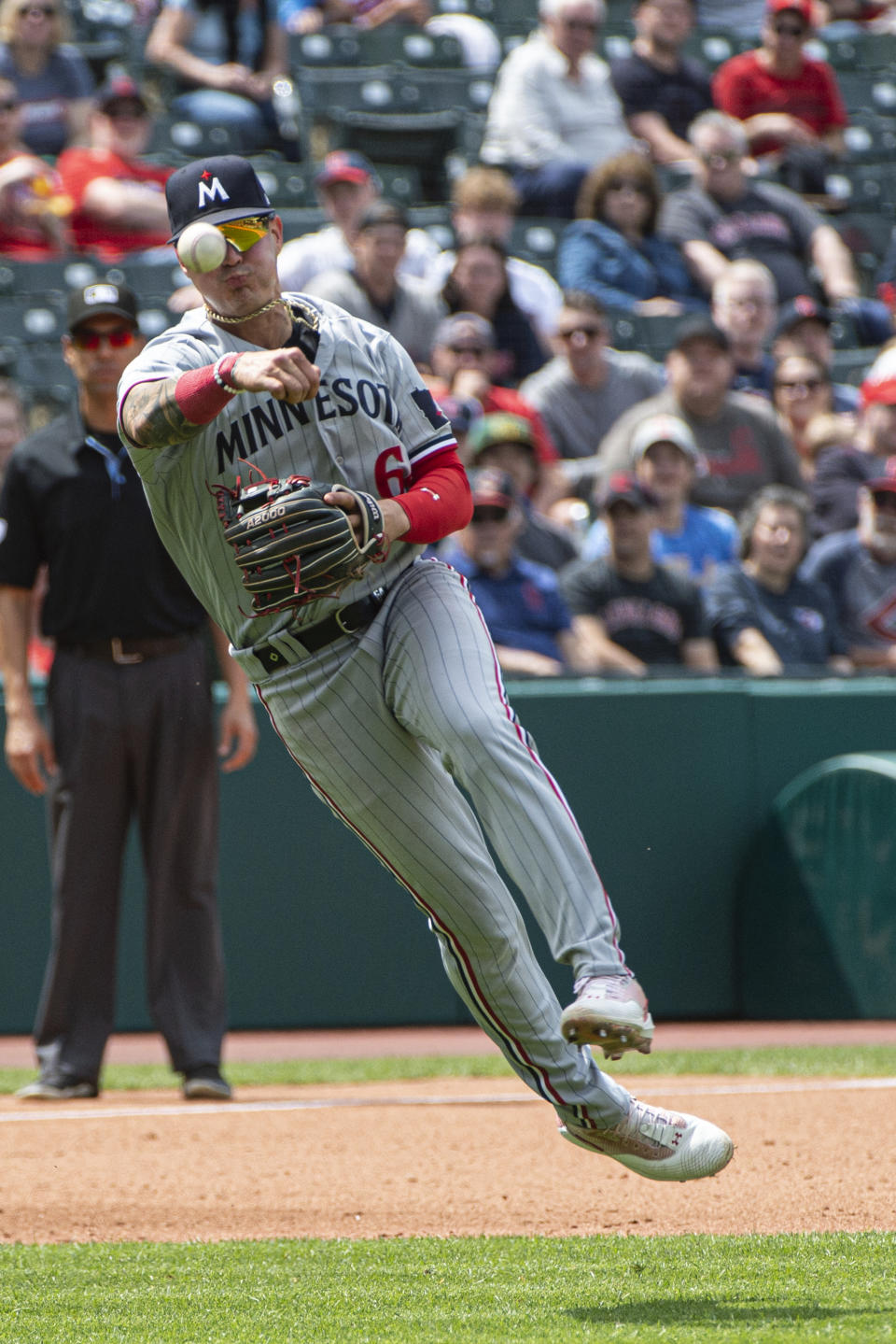 Minnesota Twins' Jose Miranda cannot make the throw in time to get Cleveland Guardians' Steven Kwan at first base during the fifth inning of a baseball game in Cleveland, Sunday, May 7, 2023. (AP Photo/Phil Long)